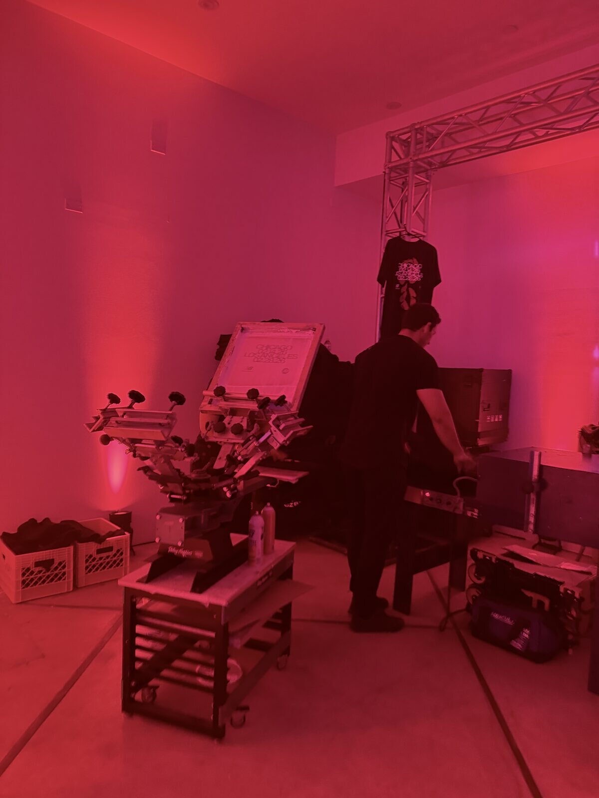 Crew preparing equipment in a red-lit lounge before an evening launch party
